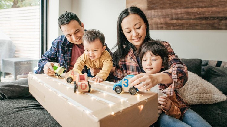 Happy Asian family using tablet, laptop for playing game watching movies, relaxing at home for lifestyle concept