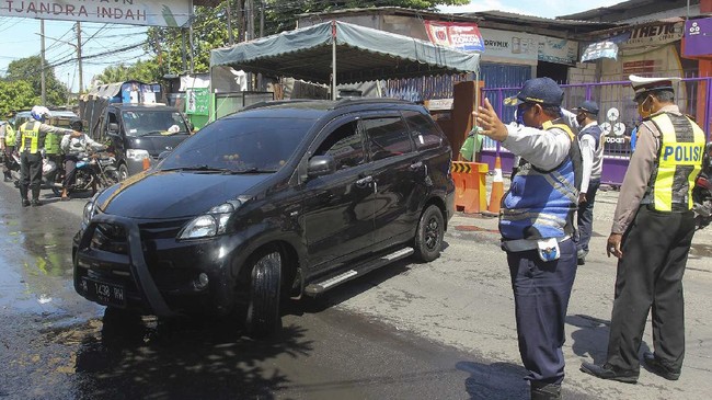 Polisi menghentikan pengendara mobil yang masuk Kota Surabaya untuk diperiksa identitasnya di Jalan Rungkut Menanggal, Surabaya, Jawa Timur, Minggu (26/4/2020). Kegiatan Operasi Ketupat Semeru 2020 dengan mendirikan pos pemeriksaan (check point) di 17 lokasi akses masuk Surabaya itu dalam rangka pelarangan mudik dan mensosialisasikan aturan-aturan Pembatasan Sosial Berskala Besar (PSBB) di Surabaya yang akan dilaksanakan pada 28 April 2020. ANTARA FOTO/Didik Suhartono/foc.