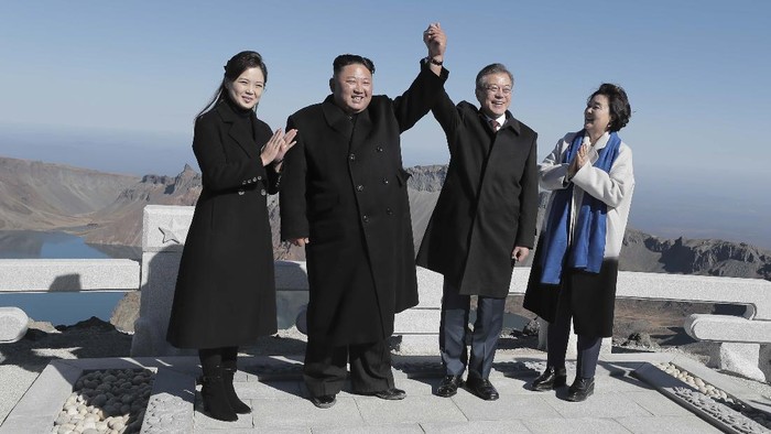 MOUNT PAEKTU, NORTH KOREA - SEPTEMBER 20: (EDITORIAL USE ONLY, NO COMMERCIAL USE) North Korean leader Kim Jong Un (2nd L) and his wife Ri Sol Ju (L) pose with South Korean President Moon Jae-in (2nd R) and his wife Kim Jung-sook (R) on the top of Mount Paektu on September 20, 2018 in Mount Paektu, North Korea. Kim and Moon meet for the Inter-Korean summit talks after the 1945 division of the peninsula, where they will discuss ways to denuclearize the Korean Peninsula. (Photo by Pyeongyang Press Corps/Pool/Getty Images)