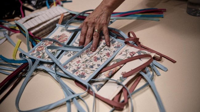 A picture shows face masks made out of fabric by seamstresses from the Opera de Marseille in the sewing workshop of the Marseille opera house on April 20, 2020, in Marseille, southeastern France, as the country is under lockdown to stop the spread of the COVID-19 pandemic, caused by the novel coronavirus. - Usually accustomed to making production costumes,  dressmakers and seamstresses in opera houses across France, including Marseille, Bordeaux and Paris, have converted their trade to manufacturing face masks amid the coronavirus crisis. (Photo by Anne-Christine POUJOULAT / AFP)