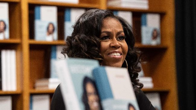 Former US first lady Michelle Obama meets with fans during a book signing on the first anniversary of the launch of her memoir 