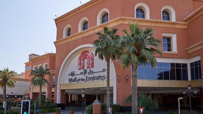 Dubai, United Arab Emirates - November 22, 2019: Mall of the Emirates shopping center building with palm trees in a sunny day