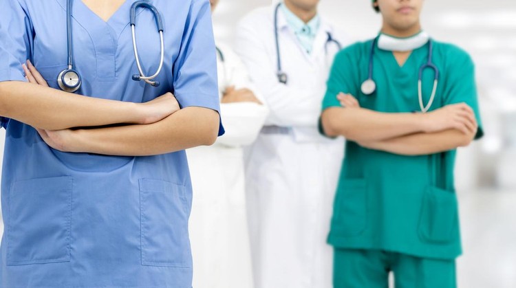 Medical team staff - General practitioner doctor, surgical doctor and nurse standing in hospital office. Healthcare business and doctor service.
