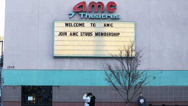 SANTA MONICA, CALIFORNIA - MARCH 17: People walk outside a closed AMC movie theater on March 17, 2020 in Santa Monica, California. AMC Theatres is closing all their theaters nationwide in response to the coronavirus (COVID-19) pandemic.   Mario Tama/Getty Images/AFP