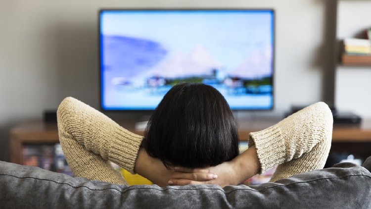young woman watching television