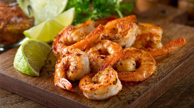 Delicious sauteed shrimp with cajun seasoning and lime on a maple plank.