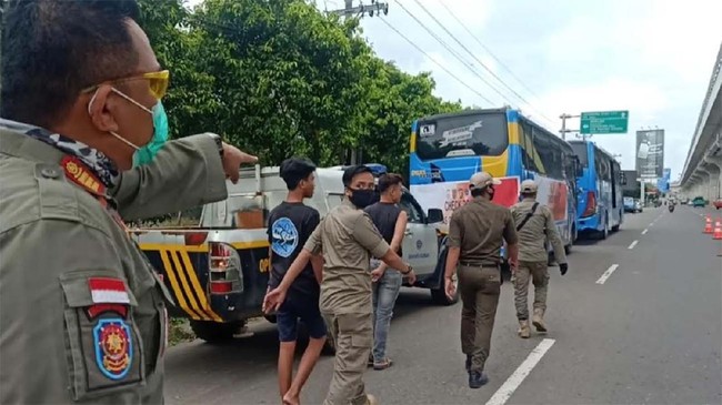 Petugas Gugus Tugas Penanganan Covid-19 Palembang melakukan patroli dalam hari pertama penerapan kebijakan wajib mengenakan masker di Palembang, Kamis (30/4). Dari patroli yang dilakukan hingga siang hari, 33 orang dibawa ke pusat karantina karena tidak bermasker.