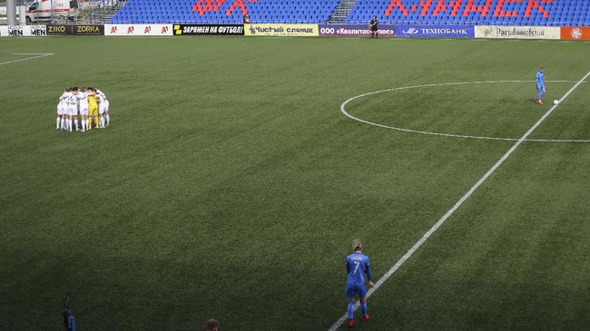 The players before the soccer match of the Women's Major League between ABFF Women's Under-19 team and Dynamo-BGUFK in Minsk, Belarus, Thursday, April 30, 2020. Belarus is one of the few countries where professional soccer is still being played in front of spectators, and the only one in Europe. The World Health Organization is urging the government of Belarus to cancel public events and implement measures to ensure physical and social distancing amid the growing coronavirus outbreak. (AP Photo/Sergei Grits)