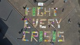 nyalang Edisi 2 Mei 2020 An aerial view shows demonstrators of the Fridays for Future environmental movement practicing social distancing as they stand next to placards arranged to form the words 'fight every crisis' in front of the city hall in Essen, western Germany, on April 24, 2020. - The climate movement Fridays for Future wants to demonstrate for more climate protection in many countries amid the Corona crisis. Because of the worldwide pandemic, the actions are taking place mainly on the Internet. (Photo by Ina FASSBENDER / AFP)