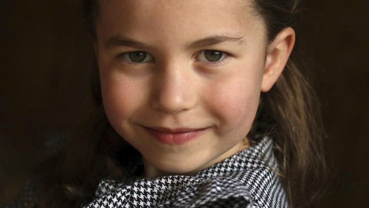 In this undated handout photo released by Kensington Palace, Britain's Princess Charlotte helps to deliver food packages for isolated pensioners in the local area along with her family, on the Sandringham Estate in King's Lynn, England. Princess Charlotte celebrates her fifth birthday on Saturday, May 2, 2020. (Duchess of Cambridge/Kensington Palace via AP)