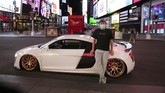 Tanpa Kemacetan Kolektor Mobil Mewah Ambil Alih Times Square In this Saturday, May 2, 2020 photo, Danny Lin poses for photos with his 2008 Audi R8 in New York's Times Square during the coronavirus pandemic.