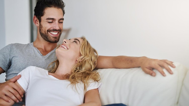 Shot of a young couple relaxing at home