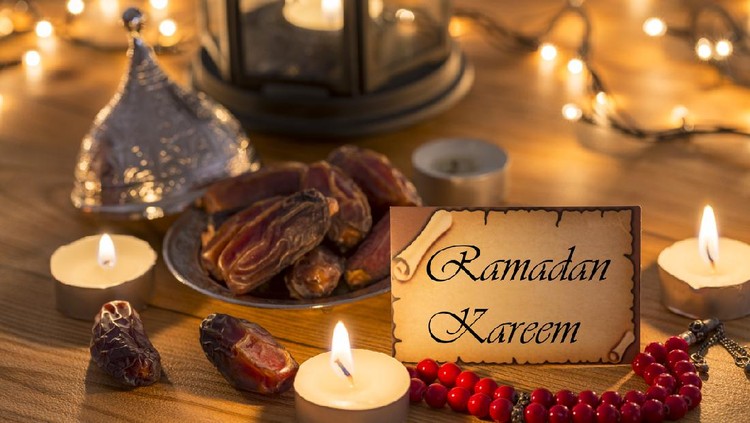 Greeting card Ramadan Kareem with dates, rosary, candles in brown wooden table