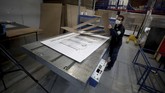 Tempat Tidur Sekaligus Peti Mati A worker at a company that designs packaging for product displays assembles a cardboard box designed to serve as both a hospital bed and a coffin, intended for COVID-19 patients, in Bogota, Colombia, Friday, May 8, 2020. Owner Rodolfo Gomez said he plans to donate the first units to Colombia's Amazonas state, and that the company will sell others to small hospitals for 87 dollars. (AP Photo/Fernando Vergara)