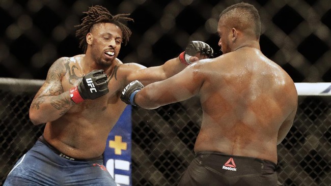 Greg Hardy, left, punches Morgan DeCastro during a UFC 249 mixed martial arts bout, Saturday, May 9, 2020, in Jacksonville, Fla. (AP Photo/John Raoux)
