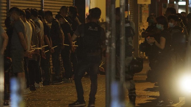 Police arrest anti-government protesters in Hong Kong, early Monday, May 11, 2020. A pro-democracy movement that paralyzed Hong Kong for months last year has shown signs of reviving in recent weeks as the coronavirus threat eases. The government recently decided to allow public gatherings of eight people, up from four previously. (AP Photo/Vincent Yu)