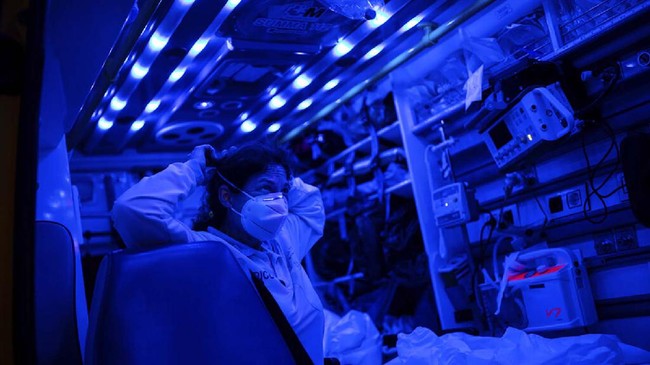 In this Thursday, May 7, 2020 photo, Dr. Monica Rodriguez of the Madrid Emergency Service (SUMMA) UVI-6 unit puts on a individual protection suit during an emergency call, amid the coronavirus outbreak in Madrid, Spain. After helping to flatten one of Europe’s sharpest contagion curves in the coronavirus pandemic, exhausted ambulance workers in Madrid fear that a resurgence in infections could throw them into another frantic period on the front line. (AP Photo/Bernat Armangue)