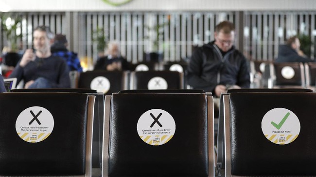 Passengers wait to board their flight at Christchurch Airport in Christchurch, New Zealand, Thursday, May 14, 2020. New Zealand lifted most of its remaining lockdown restrictions from midnight Wednesday as the country prepares for a new normal. Malls, retail stores and restaurants are all reopening Thursday in the South Pacific nation of 5 million, and many people are returning to their workplaces. (AP Photo/Mark Baker)