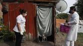 Paraguay Daratan yang A dog stands in the door of a shack where two Health Ministry workers wait for the occupant to come out to be tested for COVID-19 in Limpio, Paraguay, Wednesday, April 29, 2020. The woman inside was too ill to come to the door, so the nurse entered the home in protective gear to do the test. (AP Photo/Jorge Saenz)