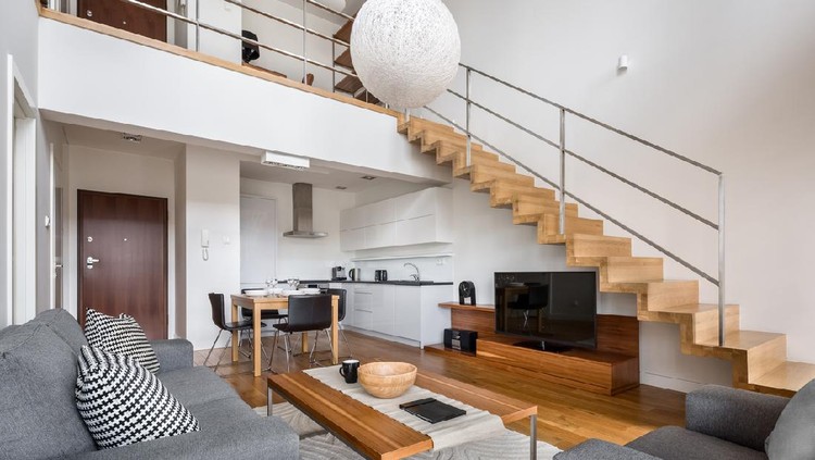 Modern two floor apartment with wooden stairs and living room open to kitchen