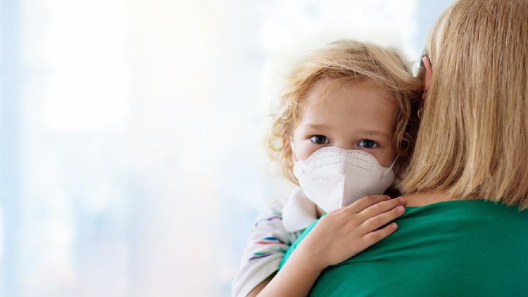 Family with kids in face mask in shopping mall or airport. Mother and child wear facemask during coronavirus and flu outbreak. Virus and illness protection, hand sanitizer in public crowded place.