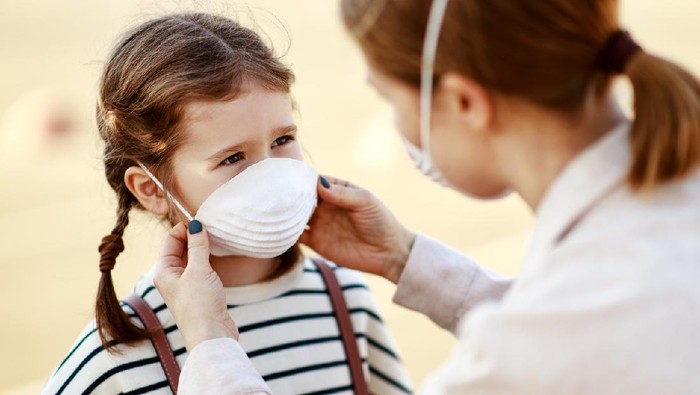 Family with kids in face mask in shopping mall or airport. Mother and child wear facemask during coronavirus and flu outbreak. Virus and illness protection, hand sanitizer in public crowded place.