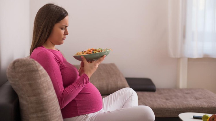 Ibu hamil Sad pregnant woman doesn't want to eat vegetables