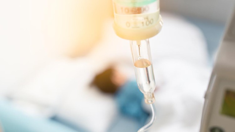 Sick child sleep on the bed in hospital during have a saline drip
