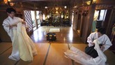 Kuil Shinto di Jepang Hibur Mereka yang Dirumah Aja In this May 8, 2020, photo, priests put ritual dress away after performing a livestream prayer during a 10-day trial of
