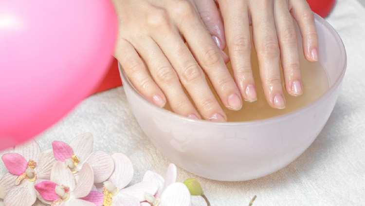 Hands care in the spa. Beautiful woman's hands with perfect manicure. Manicurist master makes manicure