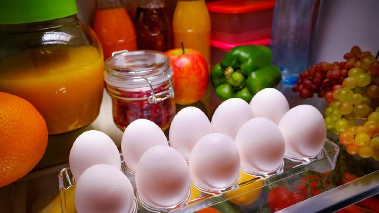 Cute female taking eggs from the fridge, attractive housewife take care about health, fresh tasty organic food, healthy eating concept