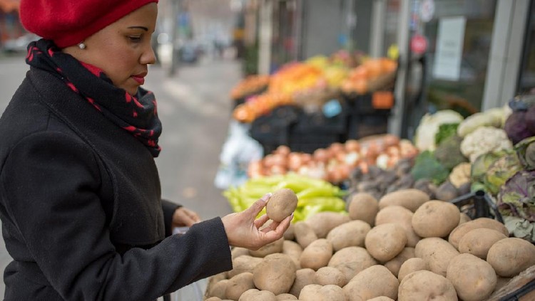 skin colored woman choosing vegetables  at traditional  market,healthy lifestyle