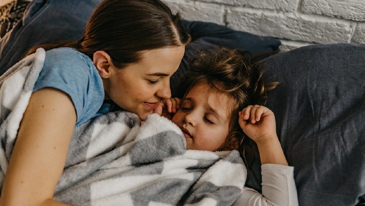 Photo of charming adorable little girl and her older sister teenager hugging each other