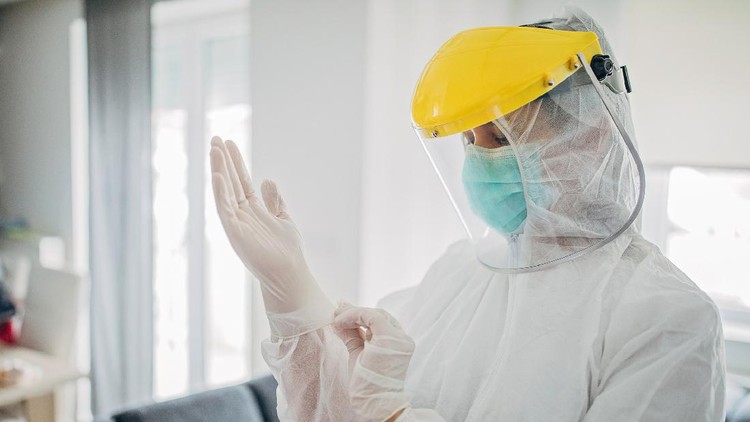 One woman, female doctor in full protective suit in home inspection.