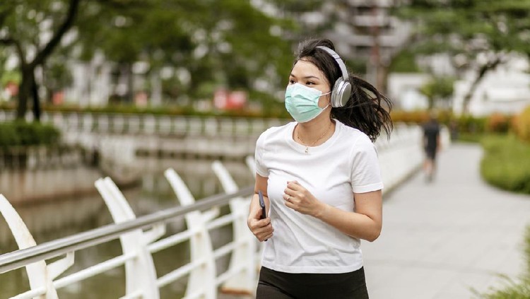a asian woman doing a exercise in a park of Jakarta City, Indonesia, during quarantine cause corona pandemic