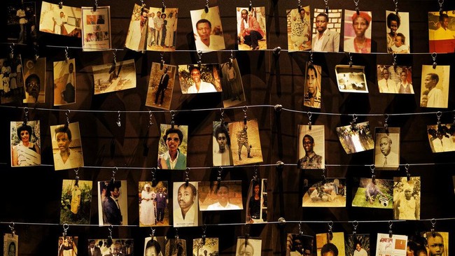 FILE - In this Friday, April 5, 2019 file photo, family photographs of some of those who died hang on display in an exhibition at the Kigali Genocide Memorial centre in the capital Kigali, Rwanda. Felicien Kabuga, one of the most wanted fugitives in Rwanda's 1994 genocide who had a $5 million bounty on his head, has been arrested in Paris, authorities said Saturday, May 16, 2020. (AP Photo/Ben Curtis, File)