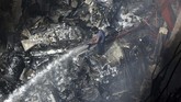 Kecelakaan Pesawat Pakistan Airlines di Karachi A firefighter tries to put out fire caused by plane crash in Karachi, Pakistan, Friday, May 22, 2020. An aviation official says a passenger plane belonging to state-run Pakistan International Airlines carrying more than 100 passengers and crew has crashed near the southern port city of Karachi. There were no immediate reports on the number of casualties. (AP Photo/Fareed Khan)