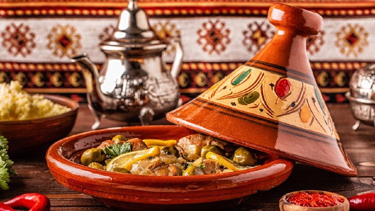 Traditional Moroccan chicken tagine with olives and salted lemons, selective focus.