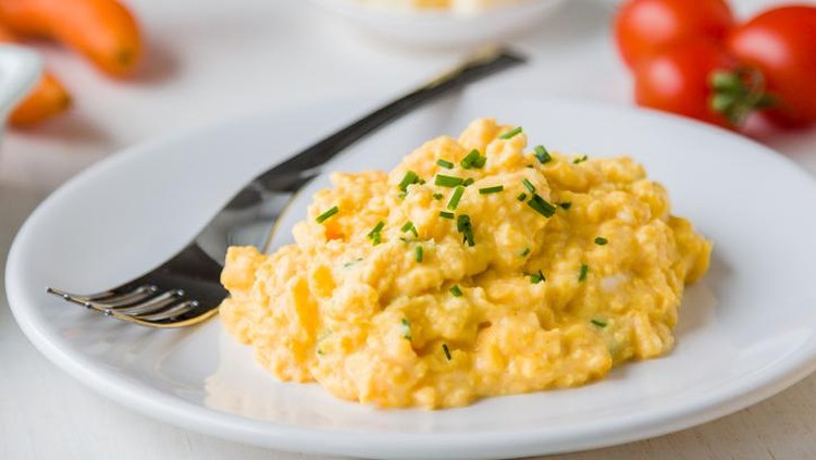 Natural light photo of farm fresh scrambled eggs on green glass plate with antique silver plated forkPlease view more rustic food images here: