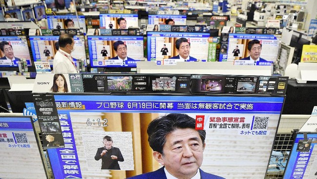 TV sets show a news conference by Japan's Prime Minister Shinzo Abe, at an electric store in Urayasu, near Tokyo Monday, May 25, 2020. Abe lifted a coronavirus state of emergency in Tokyo and four other remaining areas on Monday, ending the restrictions nationwide as businesses begin to reopen. (Kyodo News via AP)
