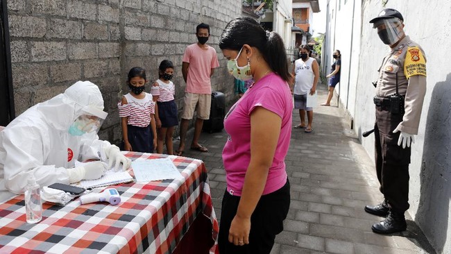 A coronavirus antibody test from health workers at a village in Bali, Indonesia, Wednesday, May 27, 2020. (AP Photo/Firdia Lisnawati)