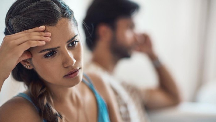Shot of a young couple having an argument while sitting on their couch at home