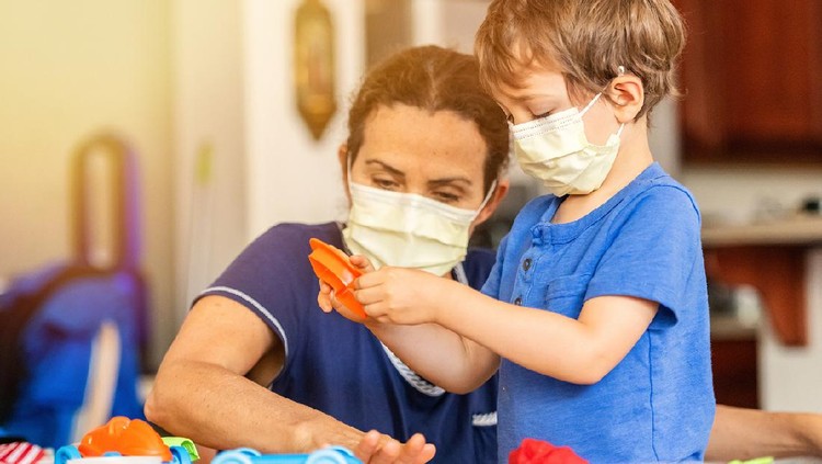 Caucasian Child boy learning with colorful clays using face masks while locked down because pandemic
