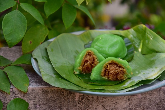 Kue Bugis, Indonesian jajan pasar, traditional snack of glutinous rice flour cake filled with sweet grated coconut, underlined with banana leaf. Popular snack during Ramadan as Takjil