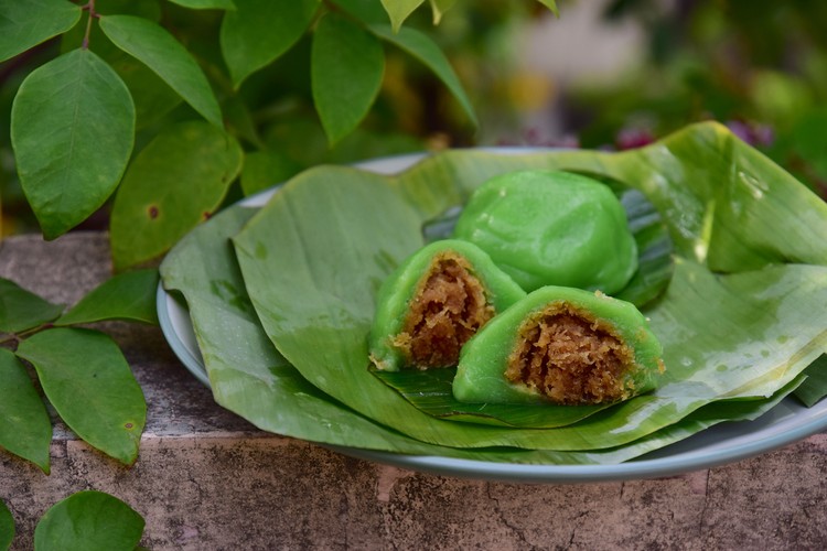 Kue Bugis, Indonesian jajan pasar, traditional snack of glutinous rice flour cake filled with sweet grated coconut, underlined with banana leaf. Popular snack during Ramadan as Takjil