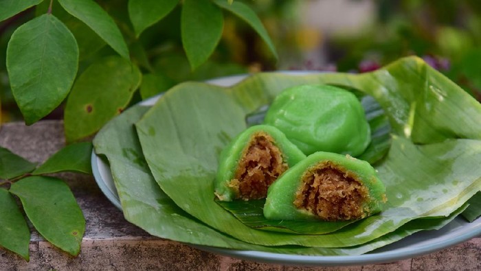 Kue Bugis, Indonesian jajan pasar, traditional snack of glutinous rice flour cake filled with sweet grated coconut, underlined with banana leaf. Popular snack during Ramadan as Takjil