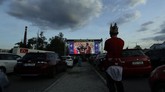 The New Normal Suporter Liga Republik Ceko A fan watches the Czech first division soccer match between Viktoria Plzen and Sparta Praha at a drive-in movie theater in Pilsen, Czech Republic, Wednesday, May 27, 2020. The match is being played live where fans can watch it on the screen at the drive in theater due to the highly contagious coronavirus. (AP Photo/Petr David Josek)