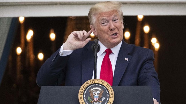 President Donald Trump listens to the music before speaking during a 