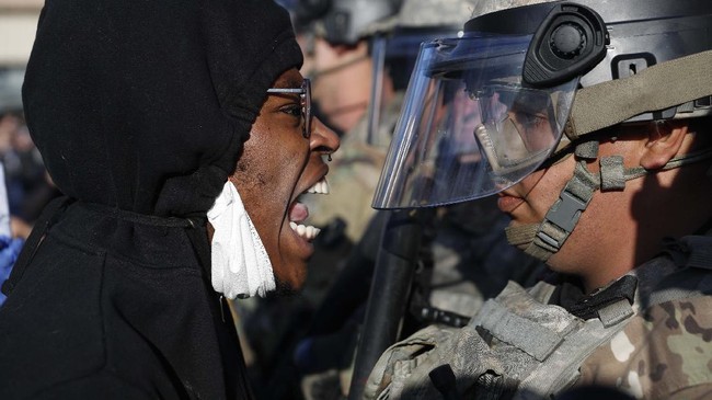 A protester yells at a member of the Minnesota National Guard Friday, May 29, 2020, in Minneapolis. Protests continued following the death of George Floyd, who died after being restrained by Minneapolis police officers on Memorial Day. (AP Photo/John Minchillo)