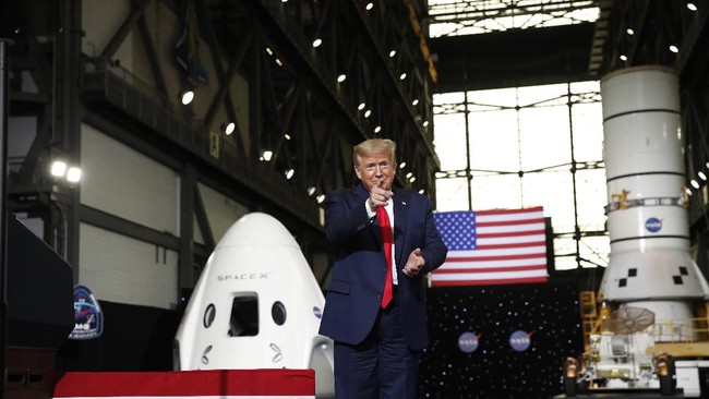 President Donald Trump points as he walks to the podium to speak during an event at the Vehicle Assembly Building on Saturday, May 23, 2020, after viewing the SpaceX flight at NASA's Kennedy Space Center in Cape Canaveral, Fla. A rocket ship designed and built by SpaceX lifted off on Saturday with two Americans on a history-making flight to the International Space Station. (AP Photo/Alex Brandon)